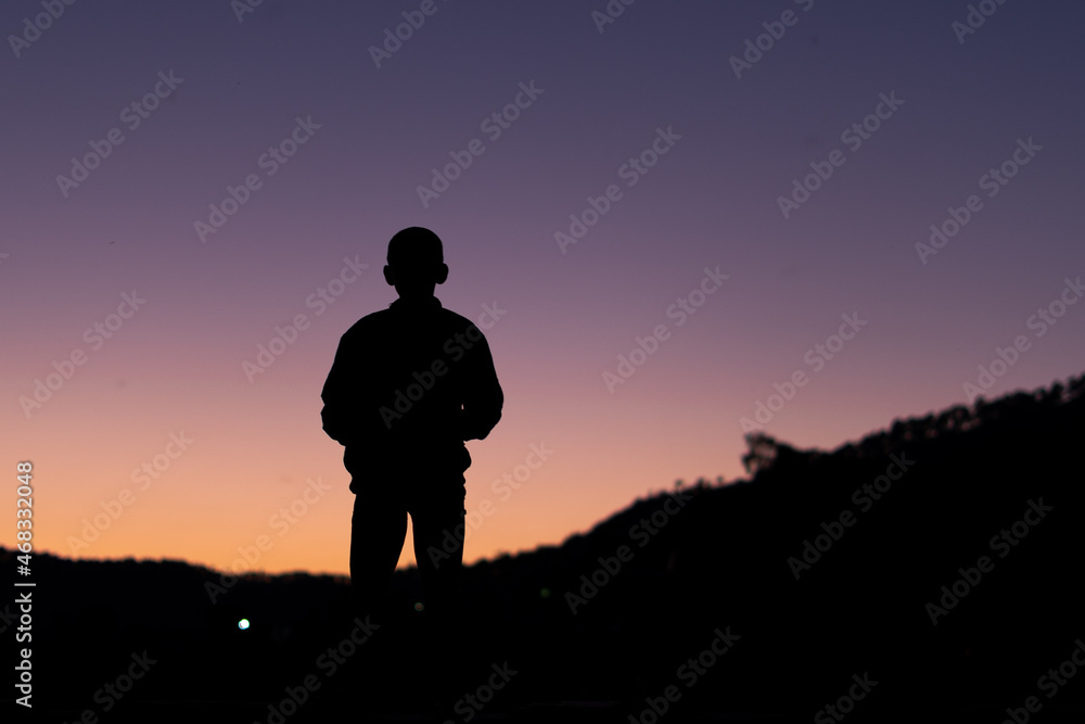 silhouette of a young boy during sunset