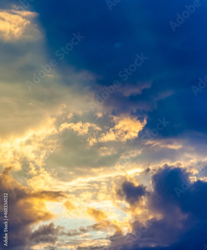 Pre-storm sky with clouds in the rays of the setting sun