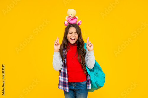 glad kid has long curly hair carry school backpack hold toy on yellow background, school