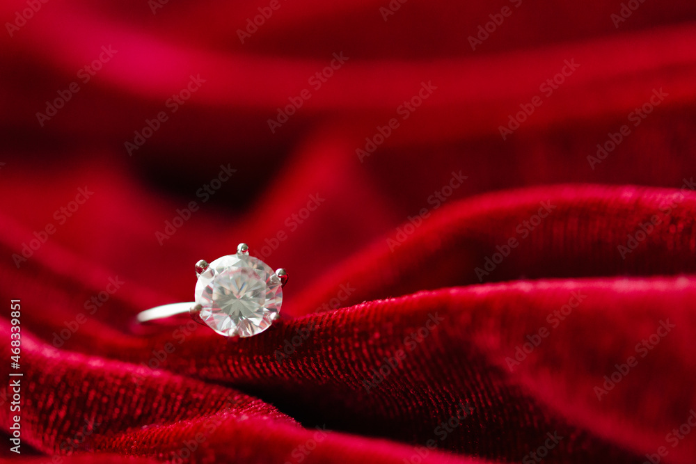 Diamond ring on red fabric background Diamond ring on red fabric background