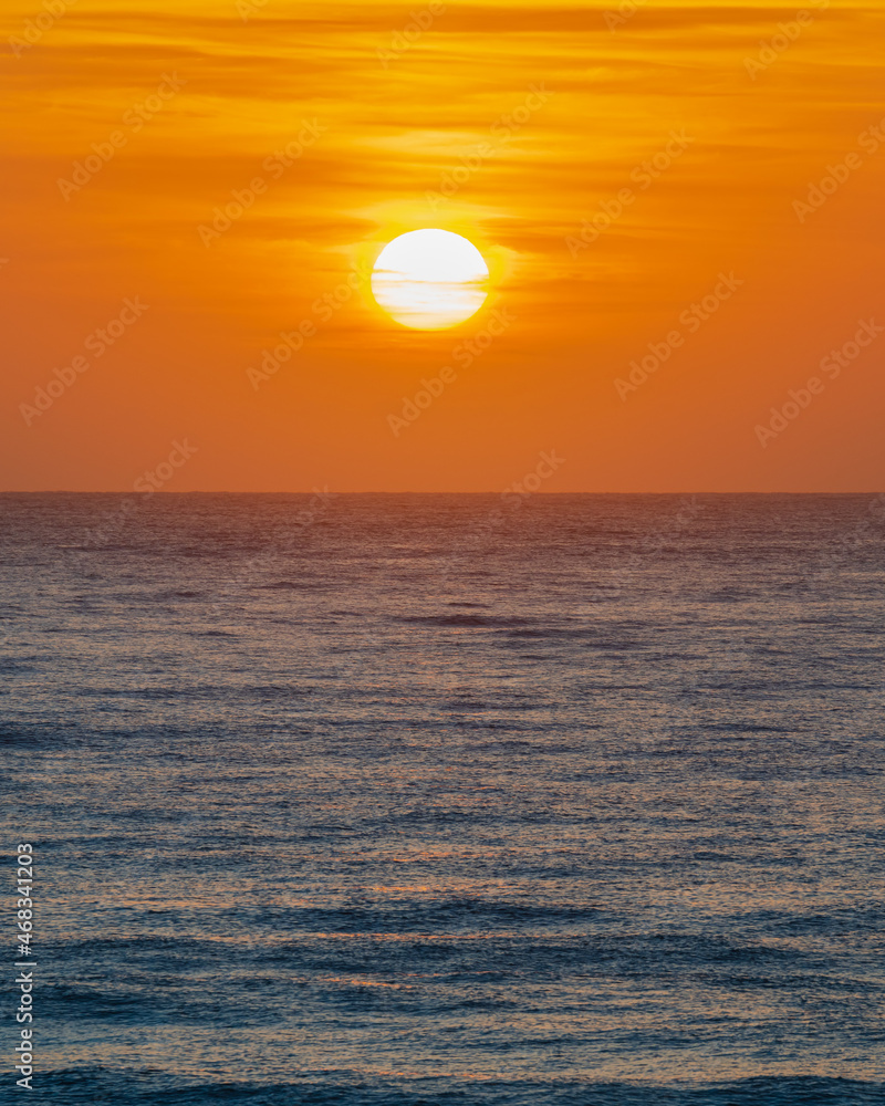 Orange sunrise with the sun over the sea