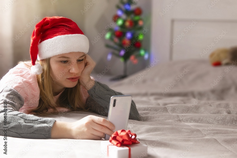 Christmas online congratulations. woman using phone for video call friends or parents. Christmas online congratulations. woman using phone for video call friends or parents.