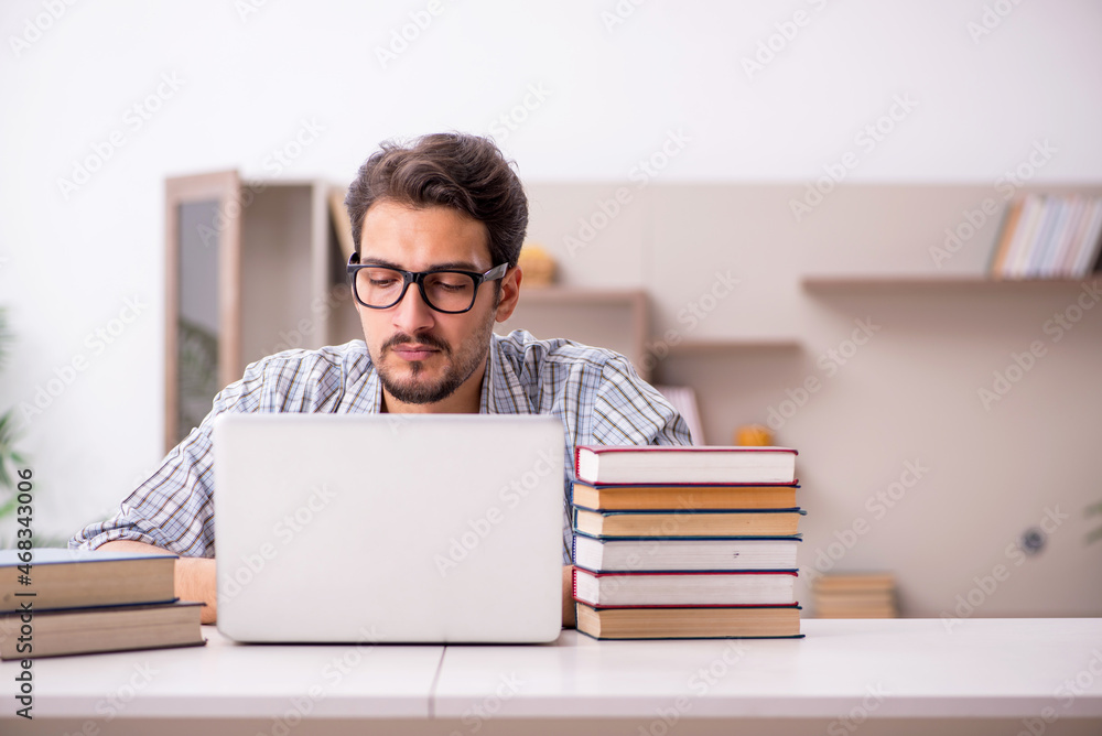 Young male student preparing for exams at home Young male student preparing for exams at home