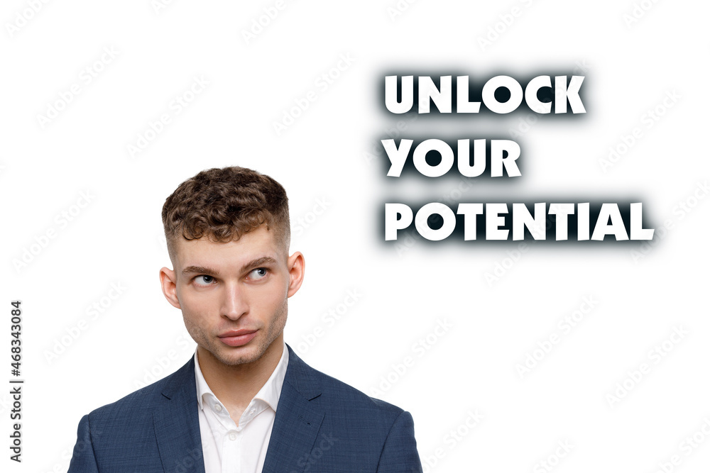 A businessman shows an inscription: UNLOCK YOUR POTENTIAL A businessman shows an inscription: UNLOCK YOUR POTENTIAL