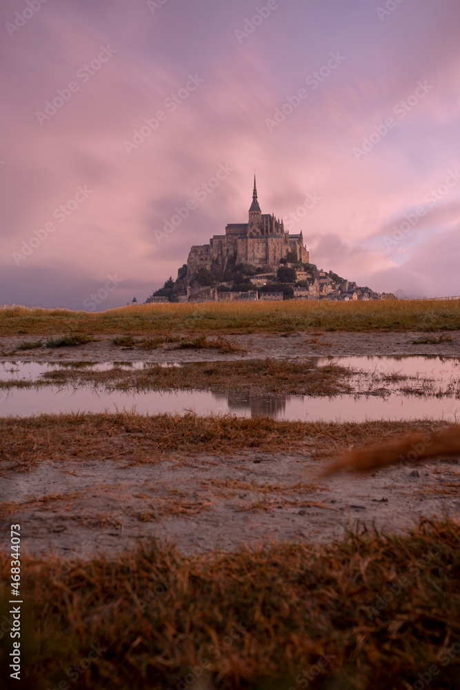 View of famous Mont Saint Michel tidal island at a beautiful sunrise time in Normandy, Northern France