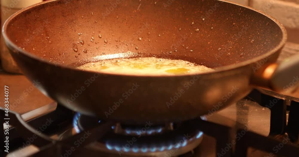 Boiling and splashing oil in skillet on gas stove Boiling and splashing oil in skillet on gas stove