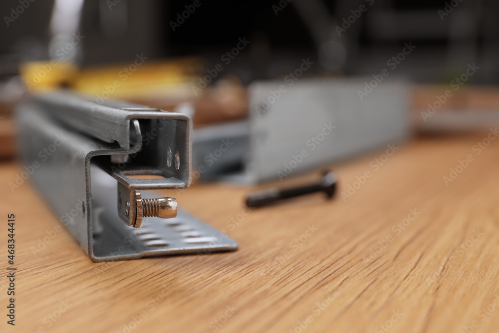 Furniture assembly parts on wooden table, closeup. Space for text Furniture assembly parts on wooden table, closeup. Space for text