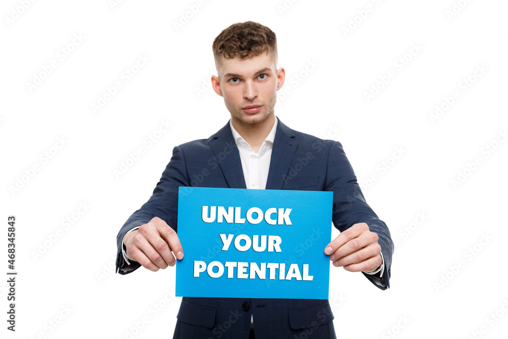 A businessman shows an inscription: UNLOCK YOUR POTENTIAL A businessman shows an inscription: UNLOCK YOUR POTENTIAL