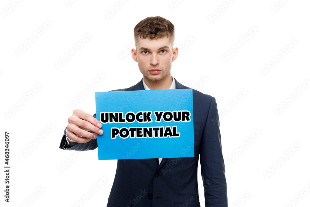 A businessman shows an inscription: UNLOCK YOUR POTENTIAL A businessman shows an inscription: UNLOCK YOUR POTENTIAL