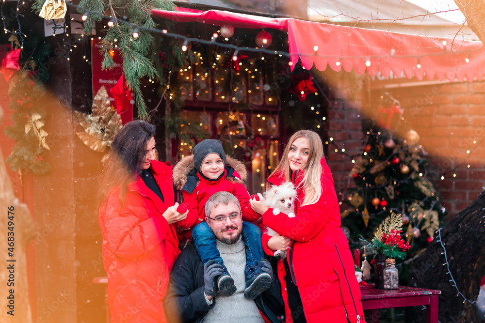 Happy family on the porch of the Christmas decorated house outdoor Happy family on the porch of the Christmas decorated house outdoor