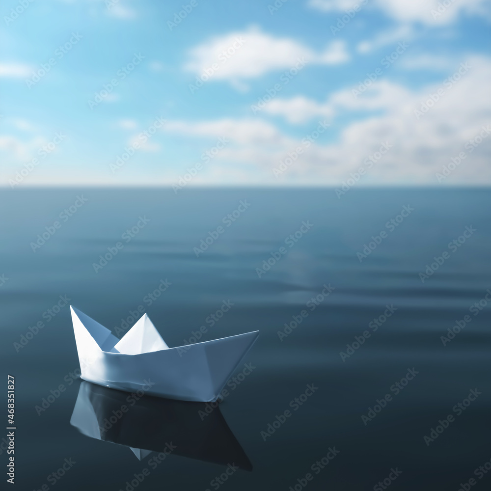 Obraz premium White paper boat floating on calm sea
