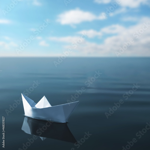 White paper boat floating on calm sea