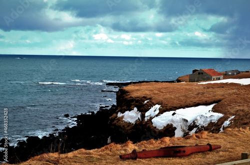 houses on the seashore in a winter cloudy day Iceland