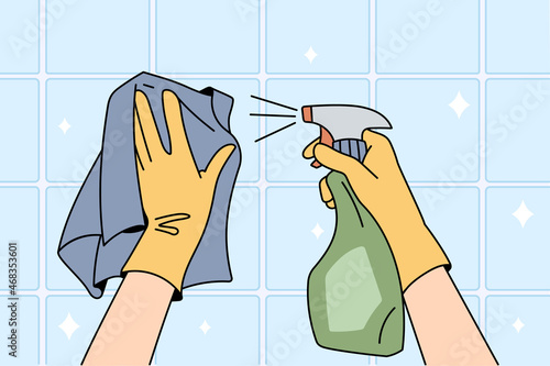 Housekeeper in gloves and napkin clean surface with spray detergent clear house. Person wipe tiles with chemical liquid. Hygiene and household concept. Flat vector illustration, cartoon character. 