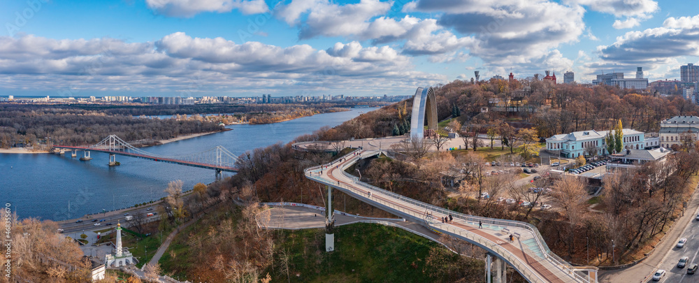 View from park Saint Vladimir Hill, on the People's Friendship Arch, Parkovy Bridge, stairs to the Monument to the Magdeburg Rights and the Dnieper River.