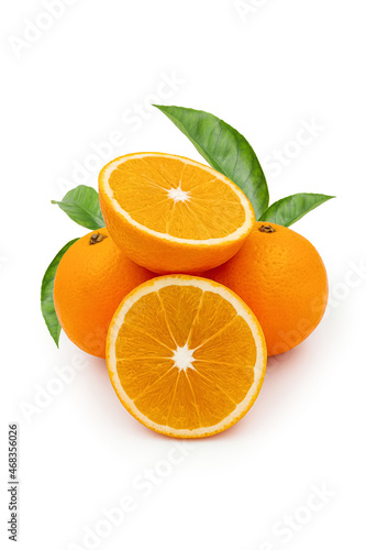 Cut and whole orange fruits with green leaves isolated on white surface