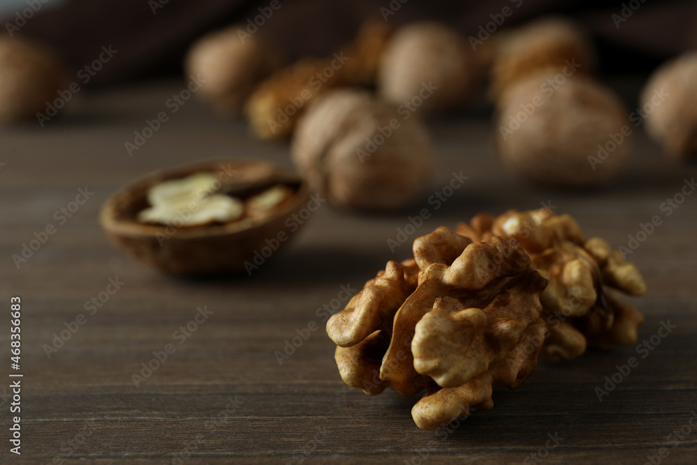 Walnuts with kitchen towel on wooden background Walnuts with kitchen towel on wooden background