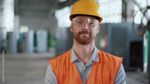 Positive man engineer in uniform looking at the camera photo