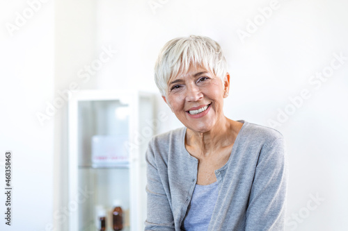 Portrait of smiling middle aged woman looking at camera. Beautiful elderly woman smiling at home.