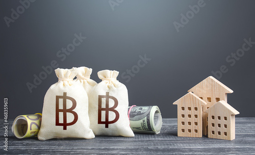 Slika na platnu Thai baht money bags and residential buildings figures