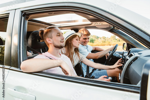 four friends in car navigation on phone © phpetrunina14
