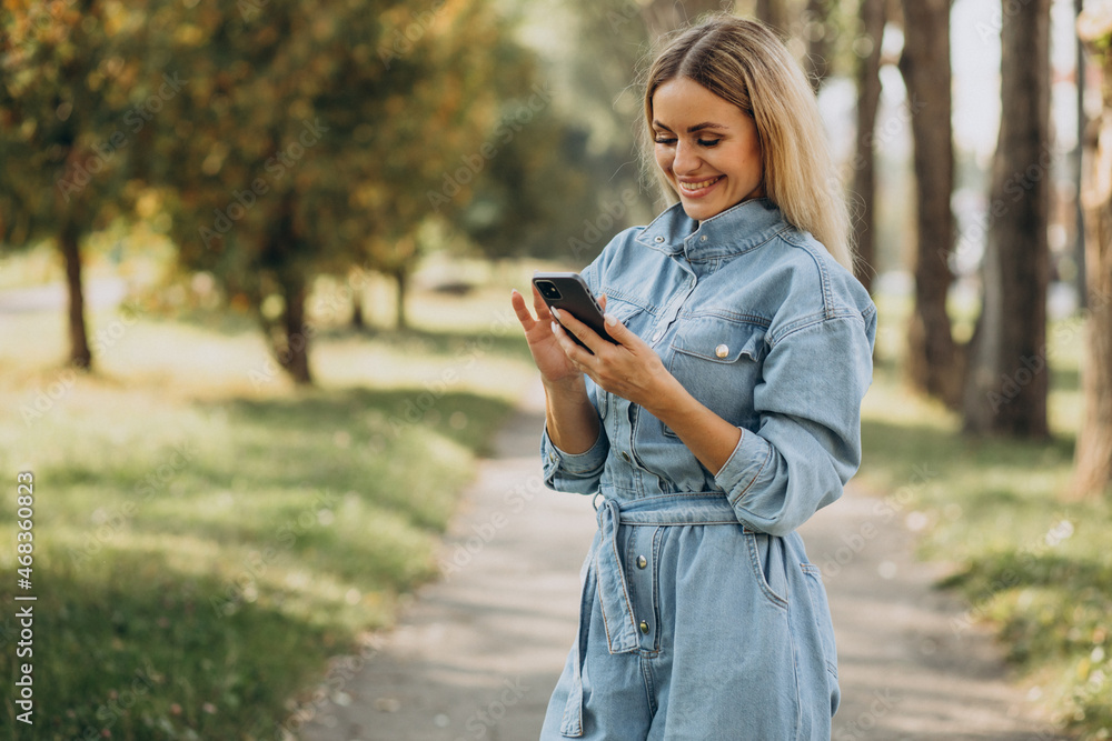 Young woman shopping online in park Young woman shopping online in park