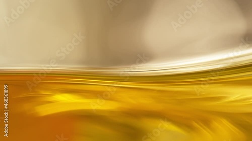 Super Slow Motion Shot of Moving Oil Waves on Golden Background at 1000fps. photo