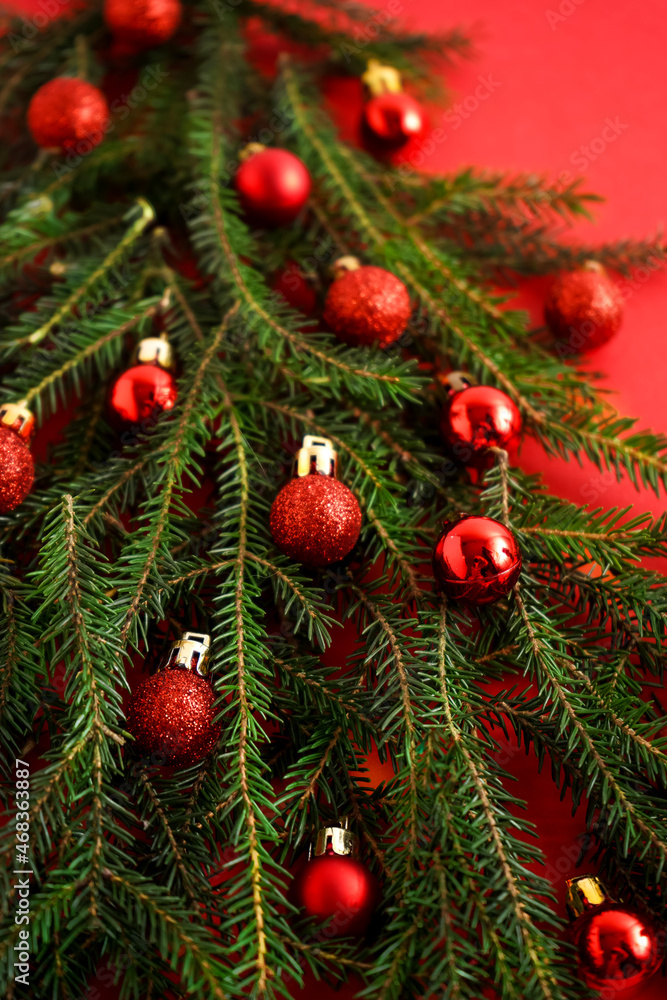 Christmas red and green background. Pine branches, needles and Christmas tree. View from above. Nature. December mood. Red balls decor. Card for new year. Christmas red and green background. Pine branches, needles and Christmas tree. View from above. Nature. December mood. Red balls decor. Card for new year.
