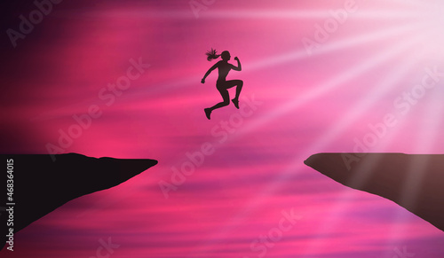 Fototapeta Naklejka Na Ścianę i Meble -  Young Woman Jumping Over Mountain Cliff At Beautiful Pink Sunset sky with Sun shine Rays. Businesswoman  Cliff Jumping. Overcoming difficulties and Female business Success Concept   