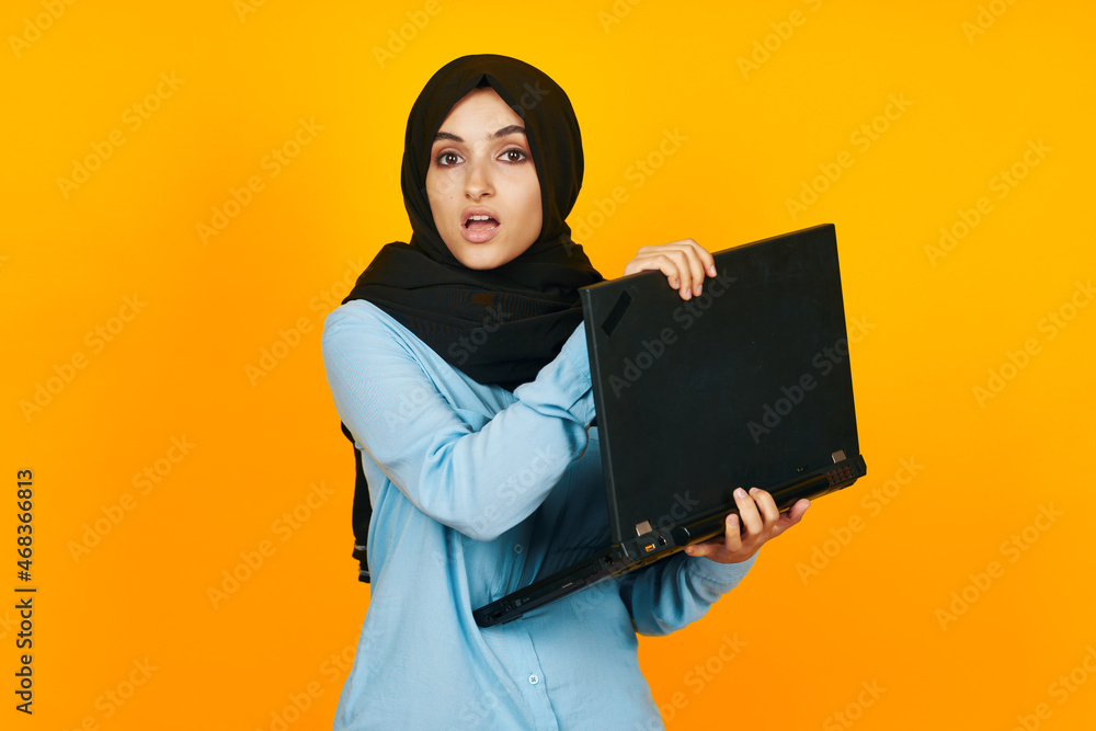 woman in black hijab with laptop in hands technology emotions studio lifestyle woman in black hijab with laptop in hands technology emotions studio lifestyle