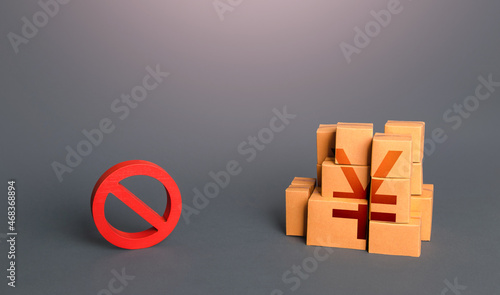 Chinese yuan or japanese yen goods boxes and prohibition symbol NO. Trade wars. A ban on import of goods. Oversupply. Confiscation of contraband. Shortage of goods. Sanctions and embargo. photo