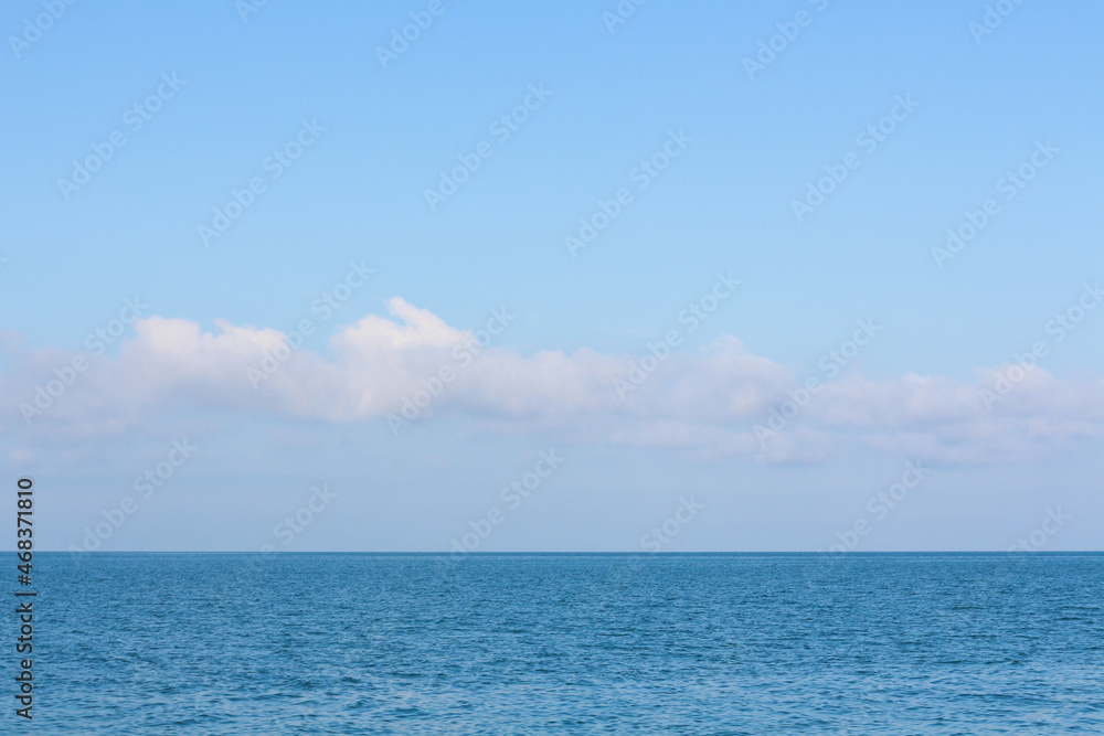 Calm blue sea or ocean with blue sky above . Peaceful relaxation
