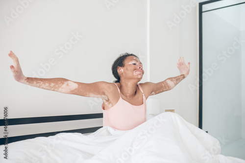 Wallpaper Mural A cute young mulatte sitting in bed and looking relaxed Torontodigital.ca