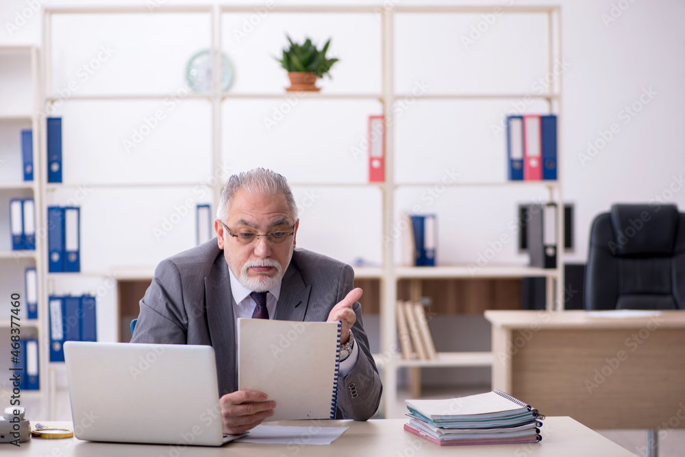 Old male employee and too much work in the office Old male employee and too much work in the office