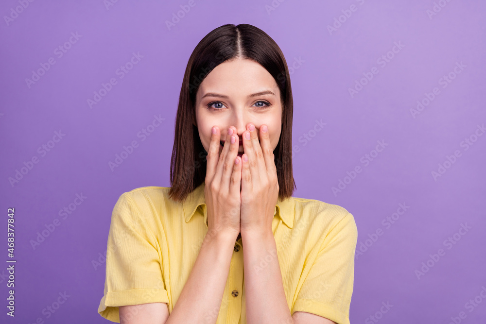 Photo of young cheerful lady cover lips arms laughing humorous joking isolated over violet color background Photo of young cheerful lady cover lips arms laughing humorous joking isolated over violet color background
