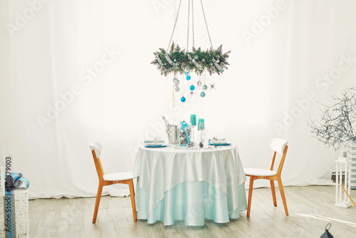 Christmas table. Blue and white decor christmas tree background. New Year celebration. Merry Christmas and Happy New Year.