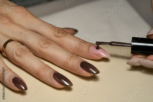 Woman doing manicure for herself. High quality photo