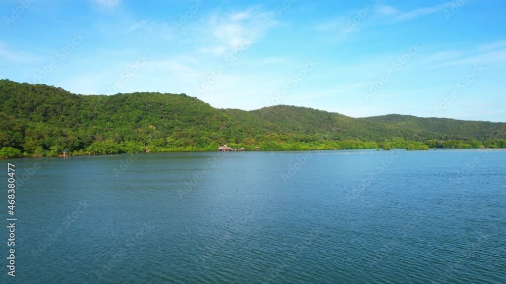 An island-shaped mangrove forest in the middle of a river mouth near the sea. shellfish farm around the mangrove forest. which is the way of life of the fishing community. Drone 4K shot.
An island-shaped mangrove forest in the middle of a river mouth near the sea. shellfish farm around the mangrove forest. which is the way of life of the fishing community. Drone 4K shot.