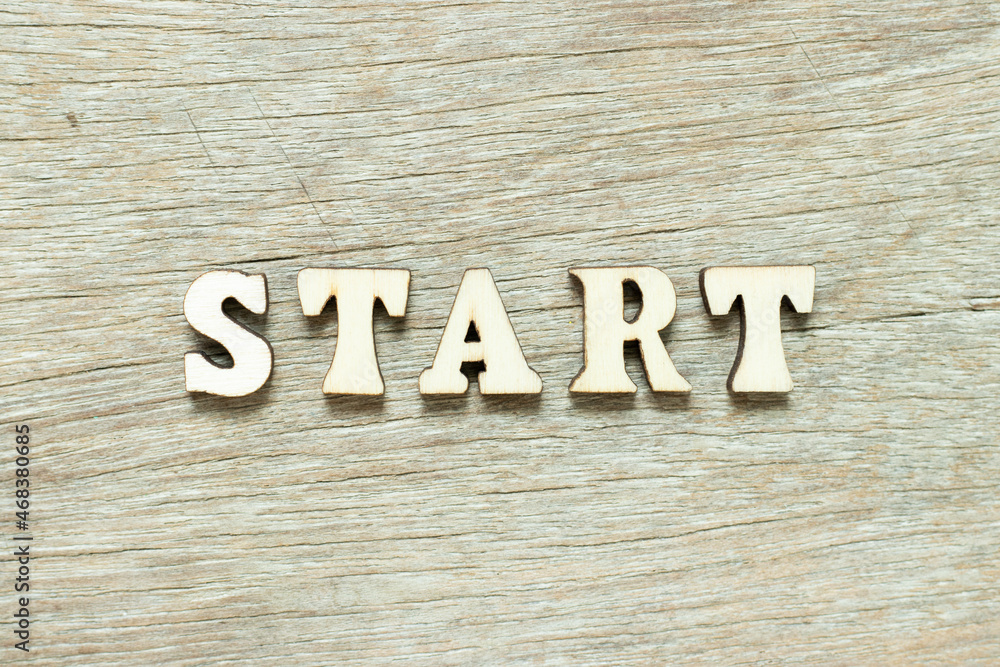 Alphabet letter in word start on wood background Alphabet letter in word start on wood background