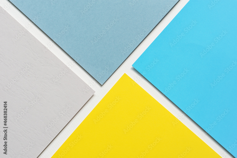 On a white background, an abstract background notion of blue and grey and yellow blank paper alignment On a white background, an abstract background notion of blue and grey and yellow blank paper alignment