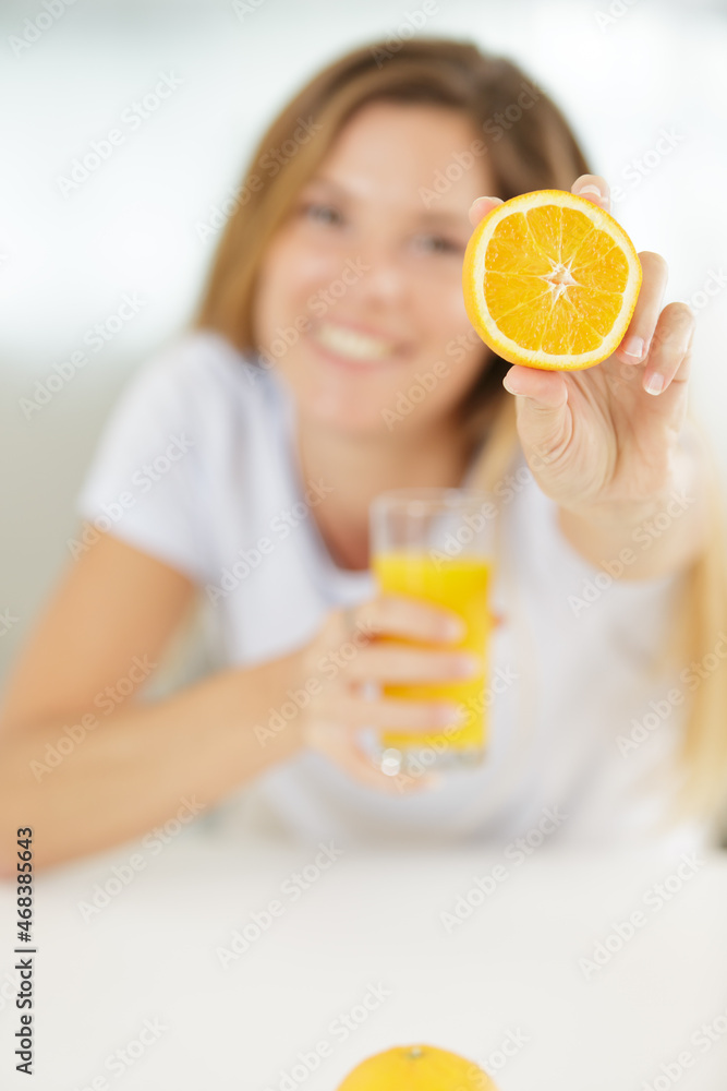 happy woman showing oranges to the camera happy woman showing oranges to the camera