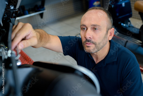 an attractive mechanic inspecting something