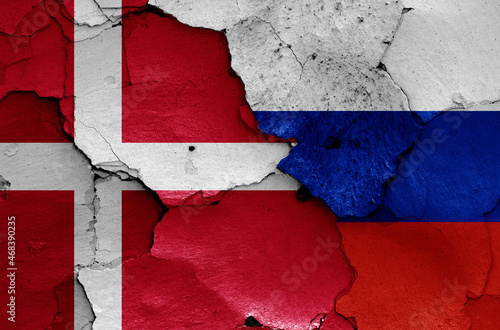 flags of Denmark and Russia painted on cracked wall