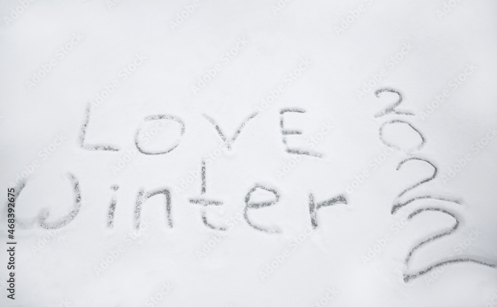 snowy surface with the inscription love winter 2022. Christmas Eve walks, fun, winter holidays. snow games snowy surface with the inscription love winter 2022. Christmas Eve walks, fun, winter holidays. snow games
