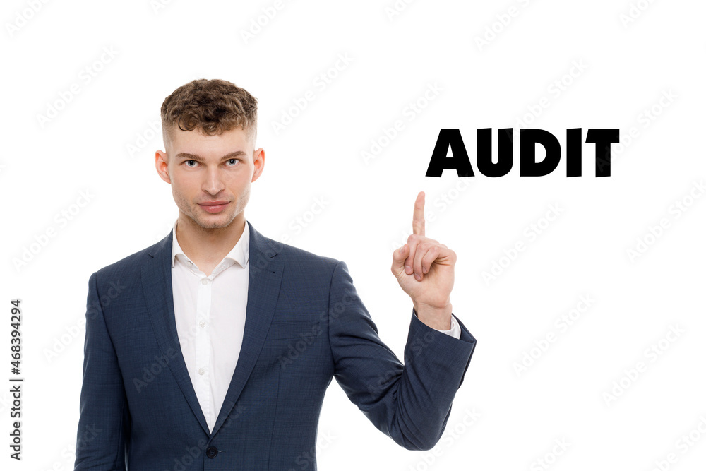 A businessman shows an inscription: AUDIT A businessman shows an inscription: AUDIT