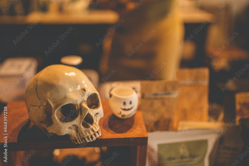 Halloween party concept decorate in cafe, decoration with human skull and pumpkin in holiday Halloween party concept decorate in cafe, decoration with human skull and pumpkin in holiday