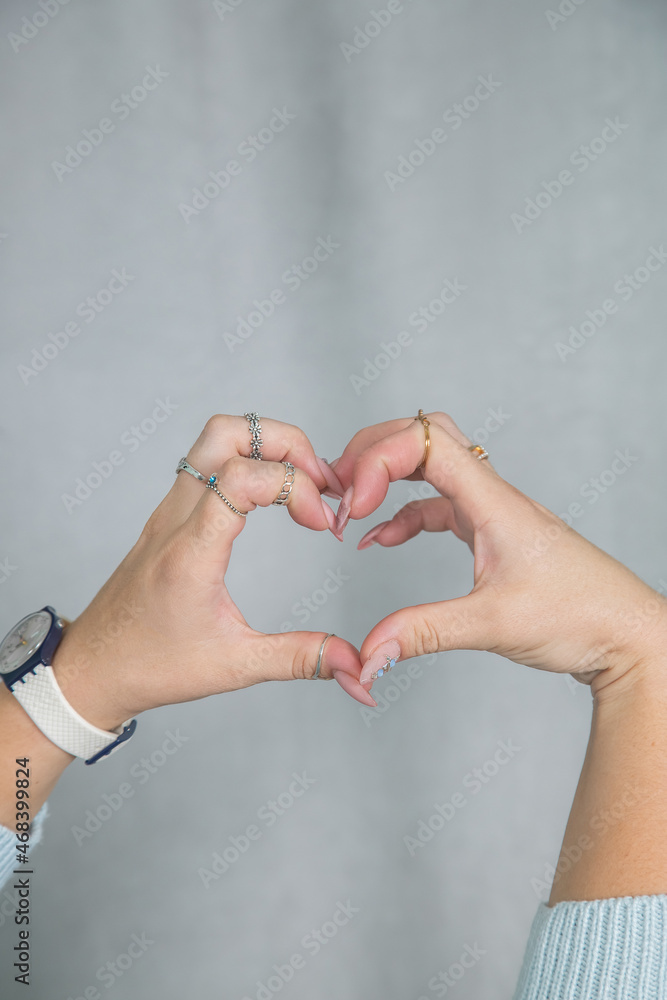 Women's hands manicure and rings are folded in a gentle elegant gesture Women's hands manicure and rings are folded in a gentle elegant gesture