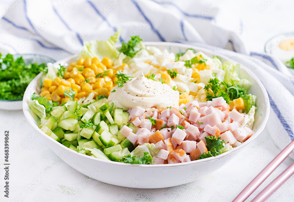Festive salad with ham, cucumber, boiled eggs, sweet corn and mayonnaise on rustic. Festive salad with ham, cucumber, boiled eggs, sweet corn and mayonnaise on rustic.