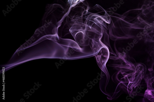 Abstract smoke Weipa. Personal aroma vaporizers. Concept of alternative non-nicotine smoking. Color vape smoke on dark background. Electronic Cigarette. Evaporator. Steaming. Blurry image, soft focus