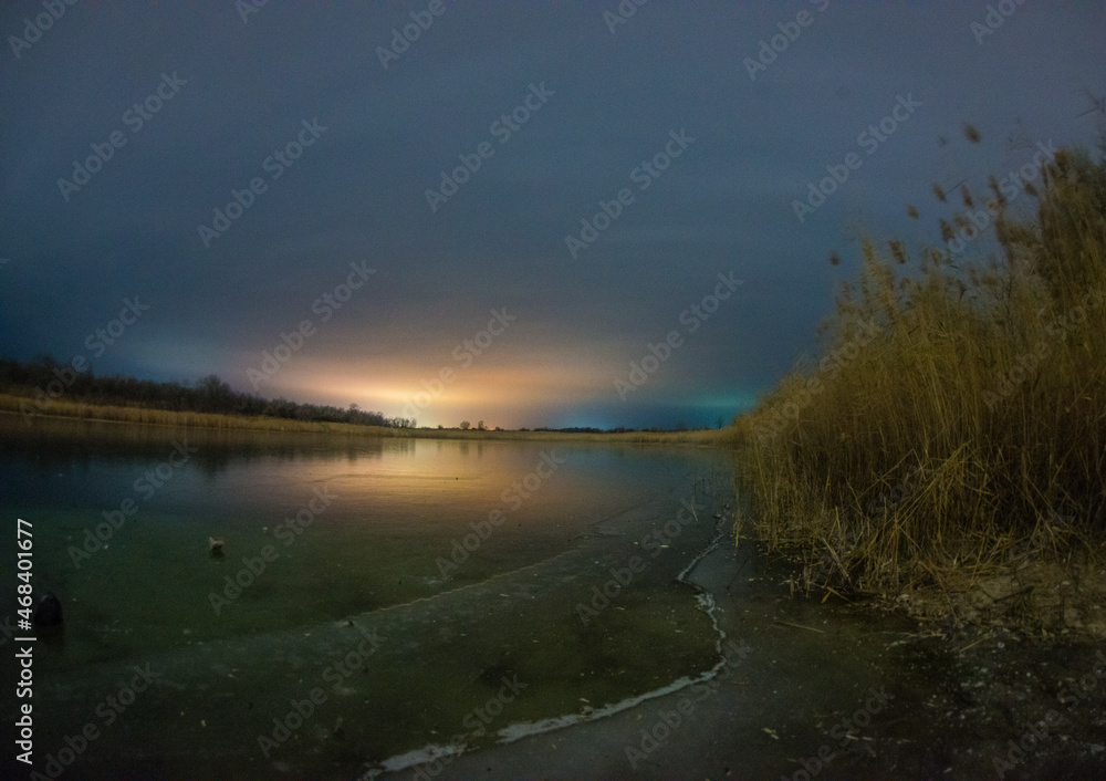 sunrise over lake forest in the night . Night landscape. Nightsky and clouds . Stars in the sky . Lights of the city  . Evening forest  . Landscapes of Ukraine . Night and morning time 